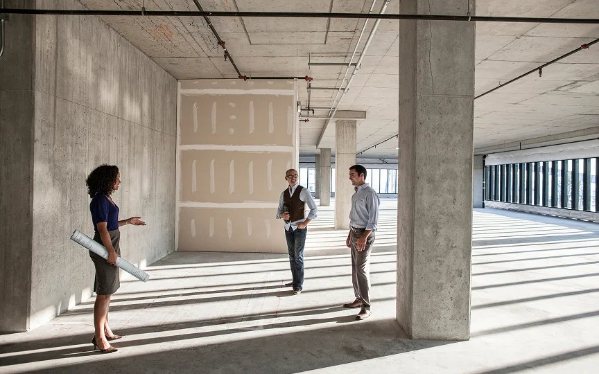 team of business people touring a new empty raw building